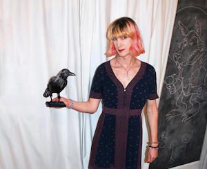 Author Charlie Jane Anders with a fake raven in her hand
