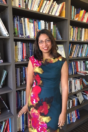 Fauzia Burke, author of Online Marketing for Busy Authors, standing in front of bookshelves